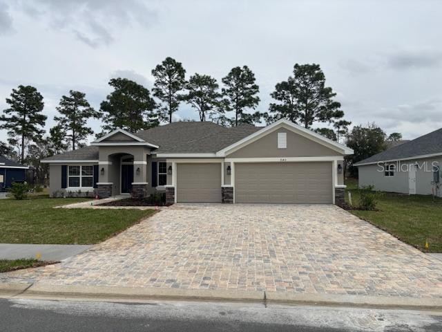 view of front of home featuring a garage and a front lawn