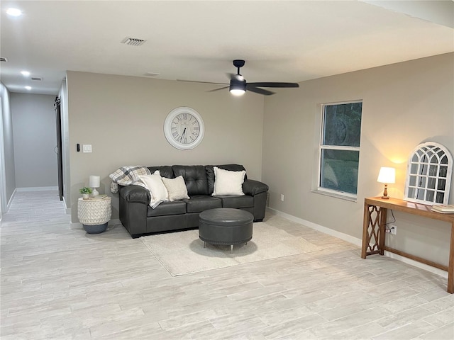 living room featuring light wood-type flooring and ceiling fan