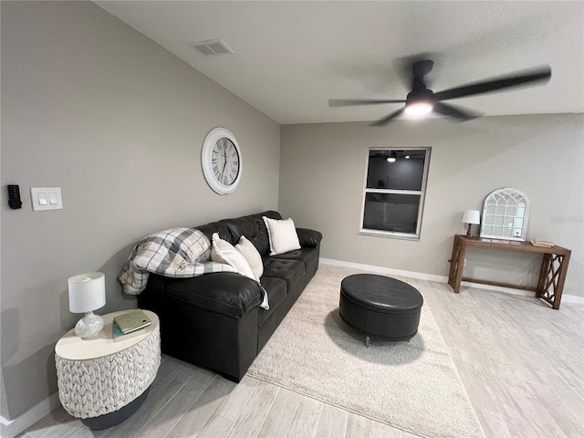 living room featuring ceiling fan and hardwood / wood-style floors