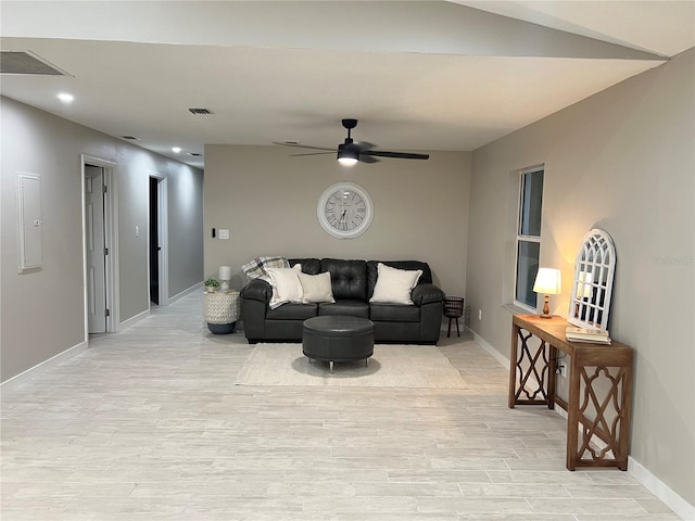 living room featuring light hardwood / wood-style floors, ceiling fan, and electric panel