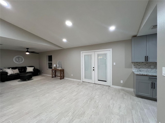 interior space with lofted ceiling, french doors, ceiling fan, and light hardwood / wood-style flooring