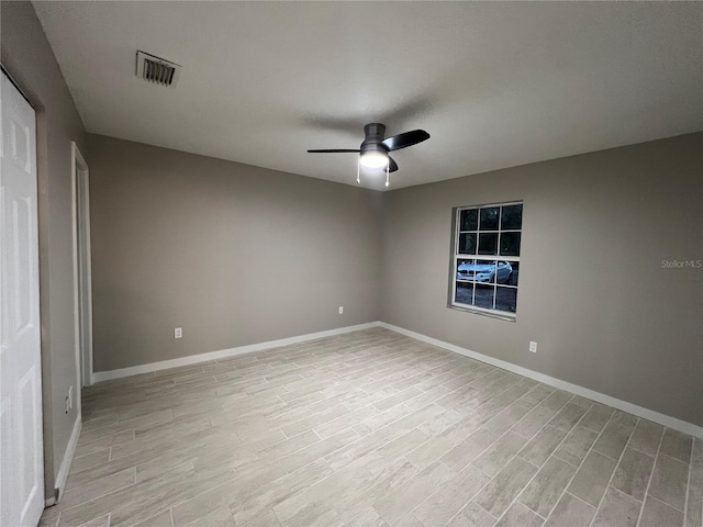 spare room with ceiling fan and light wood-type flooring