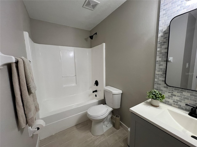 full bathroom featuring toilet, backsplash, shower / bathtub combination, and vanity