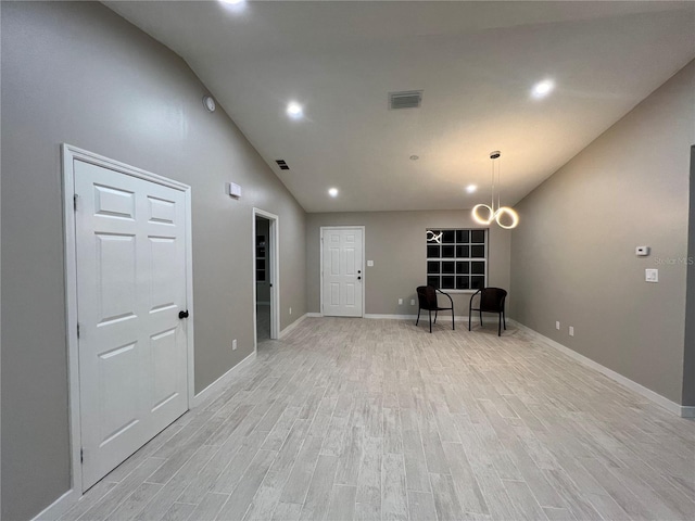 interior space with high vaulted ceiling and light hardwood / wood-style floors