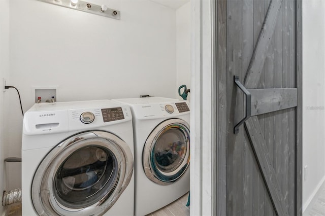 clothes washing area with washing machine and clothes dryer