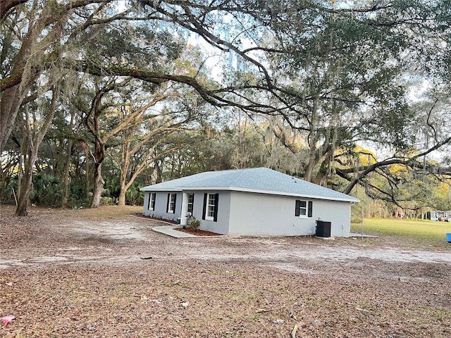 view of side of property with central air condition unit