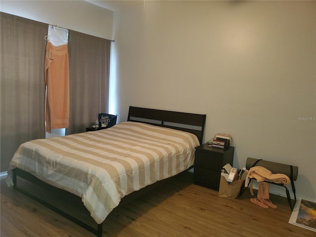 bedroom with hardwood / wood-style floors