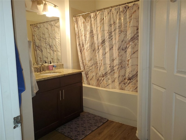 bathroom featuring wood-type flooring, vanity, and shower / bath combination with curtain