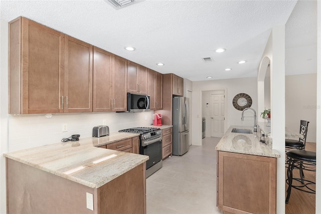 15596 SW 13th Cir, Ocala, FL 34473 - kitchen featuring stainless steel appliances, a peninsula, a sink, backsplash, and recessed lighting