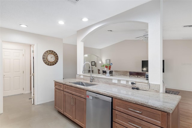 kitchen featuring dishwasher, kitchen peninsula, sink, ceiling fan, and light stone countertops