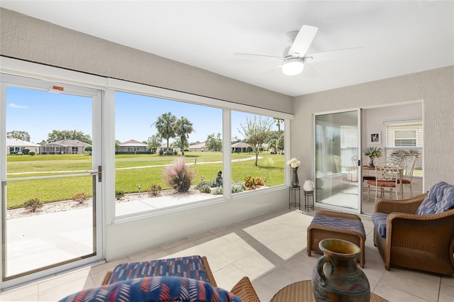 sunroom / solarium featuring ceiling fan