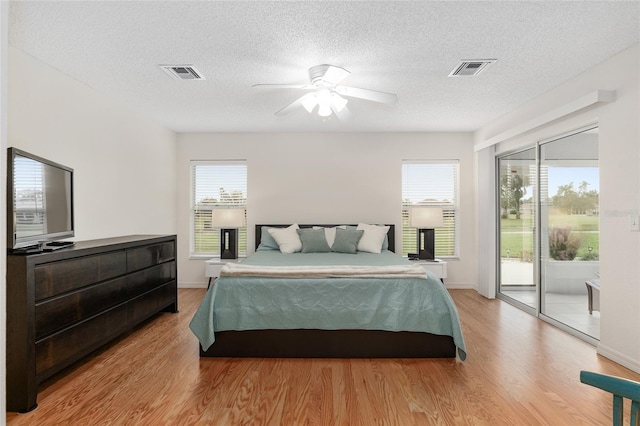 bedroom with access to outside, multiple windows, ceiling fan, and light wood-type flooring