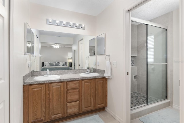 bathroom featuring vanity, a textured ceiling, an enclosed shower, tile patterned flooring, and ceiling fan