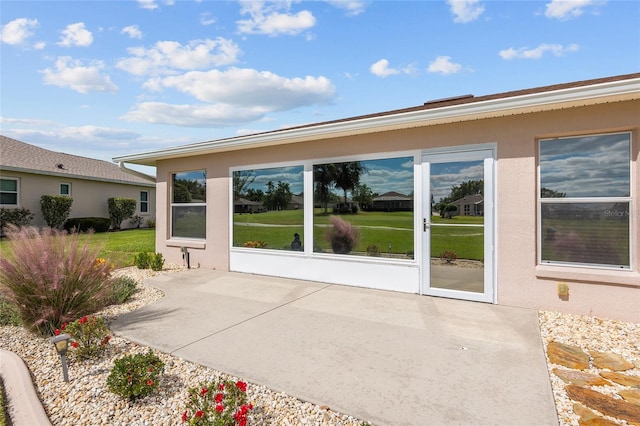 exterior space featuring a lawn and a patio area