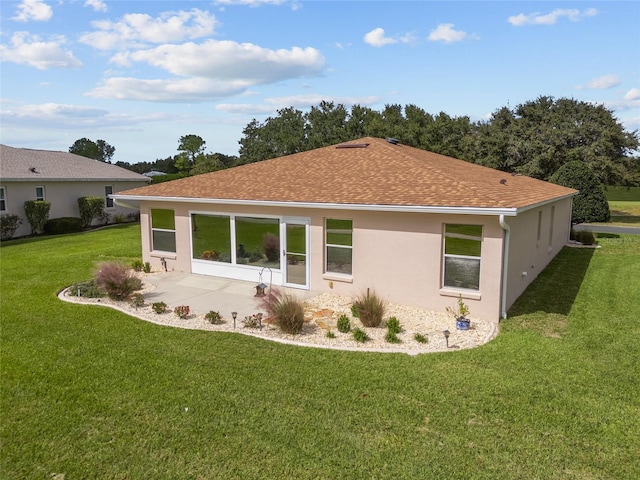 15596 SW 13th Cir, Ocala, FL 34473 - back of property featuring a yard, stucco siding, a shingled roof, and a patio