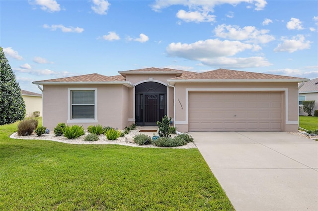15596 SW 13th Cir, Ocala, FL 34473 - view of front of house featuring stucco siding, a front lawn, driveway, and an attached garage