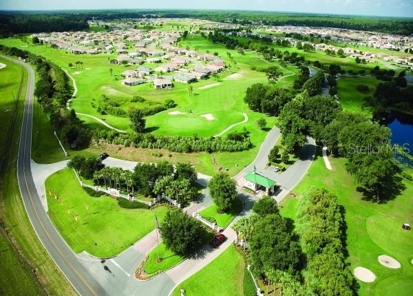 15596 SW 13th Cir, Ocala, FL 34473 - aerial perspective of suburban area featuring a golf club and a nearby body of water