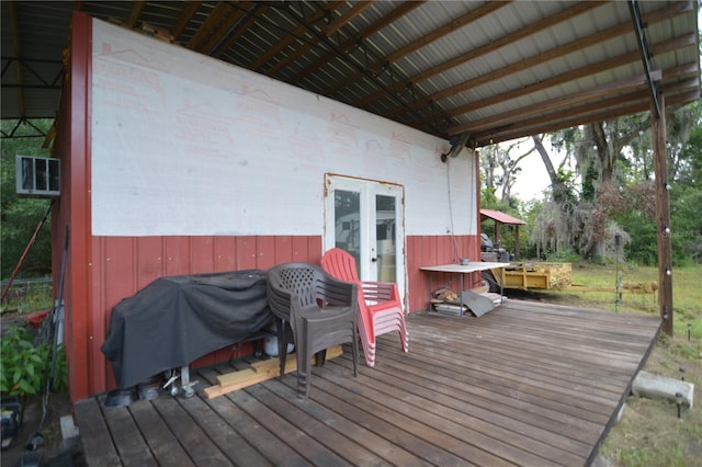 wooden deck with area for grilling and french doors