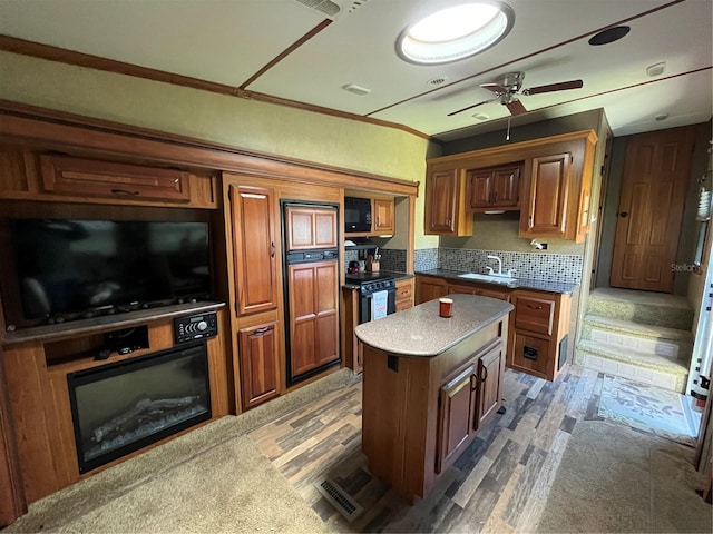 kitchen with dark wood-type flooring, ceiling fan, tasteful backsplash, and a center island