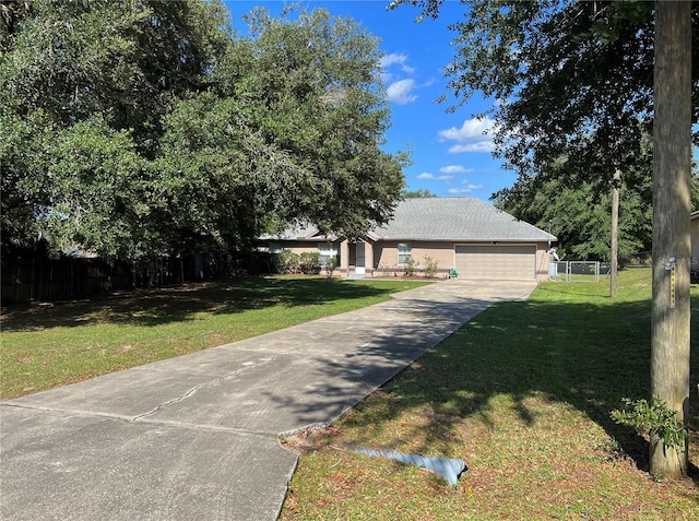 view of front of property featuring a garage and a front lawn