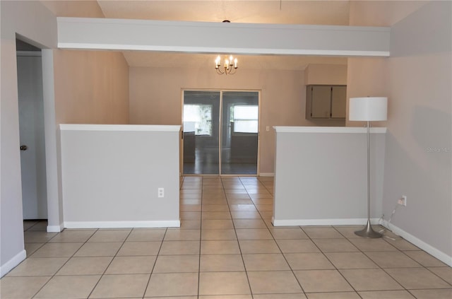 interior space with french doors, a chandelier, and light tile patterned floors