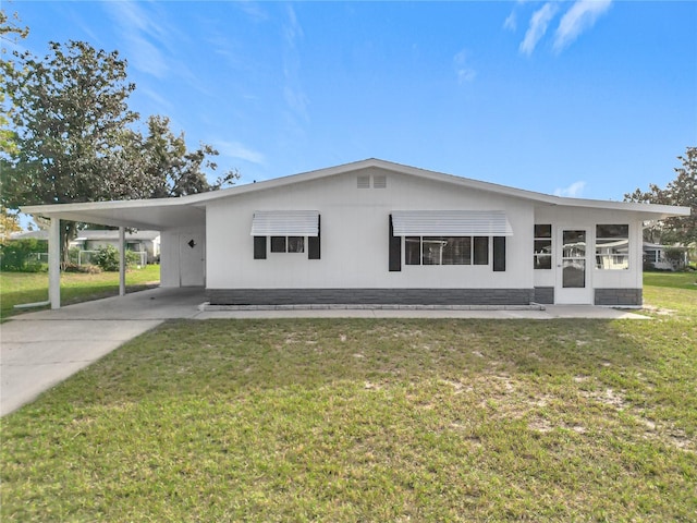 view of front facade with a carport and a front lawn