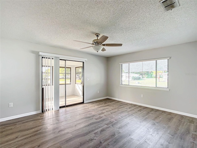 spare room with ceiling fan, hardwood / wood-style floors, and a textured ceiling