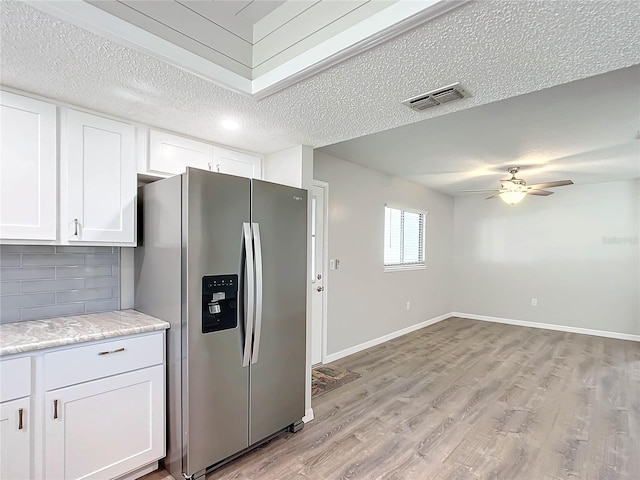 kitchen featuring white cabinets, light hardwood / wood-style flooring, decorative backsplash, a textured ceiling, and stainless steel fridge with ice dispenser