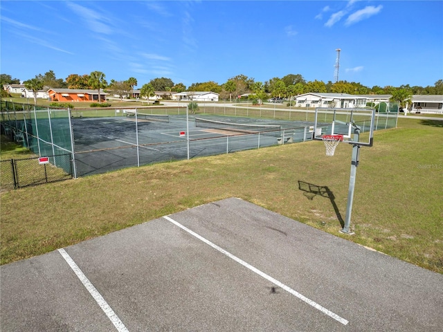 view of tennis court with a lawn