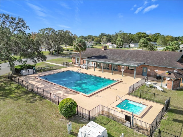 view of swimming pool featuring a patio area and a yard