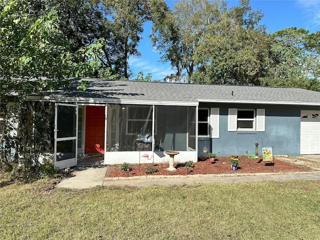 ranch-style home with a garage, a sunroom, and a front yard