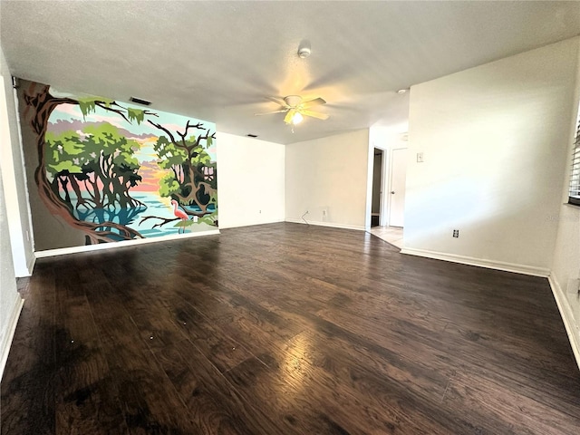 spare room featuring ceiling fan and dark hardwood / wood-style flooring