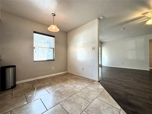 unfurnished room with a textured ceiling