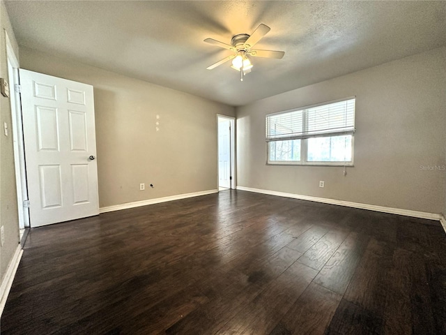 empty room with dark wood-type flooring and ceiling fan