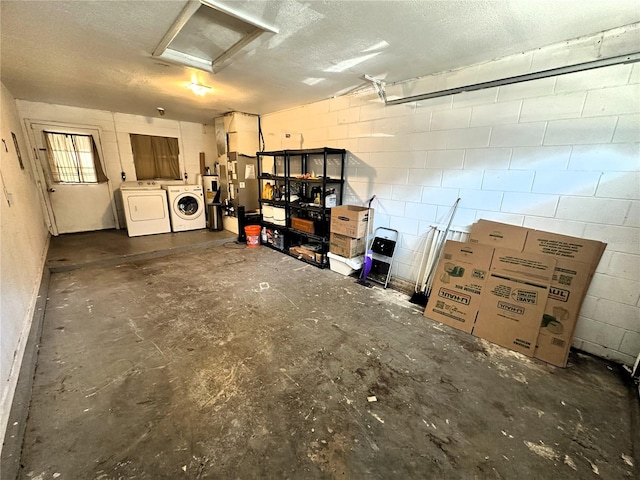 basement with washer and dryer and a textured ceiling