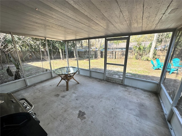 unfurnished sunroom with wood ceiling