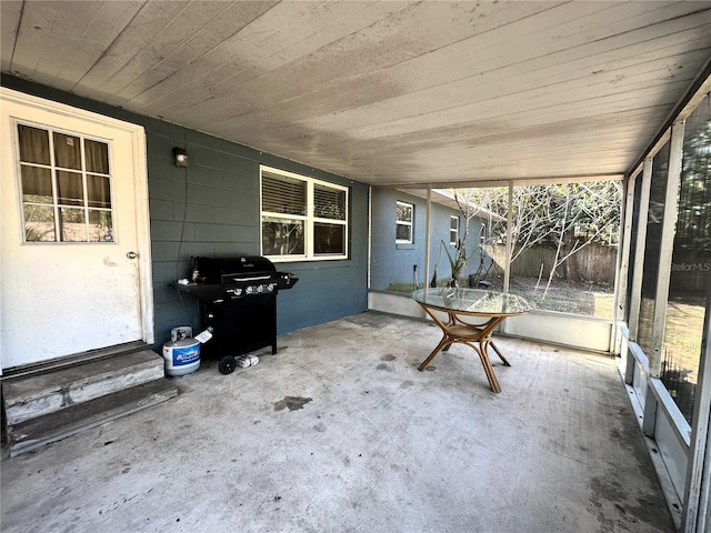 unfurnished sunroom featuring wood ceiling