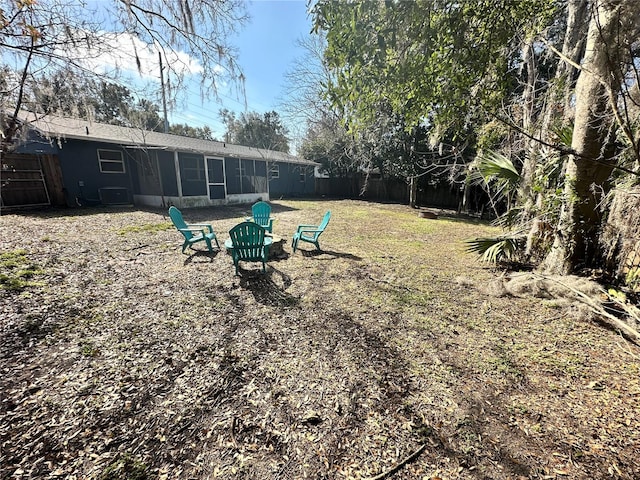 view of yard featuring cooling unit and an outdoor fire pit