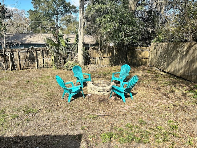 view of yard with an outdoor fire pit