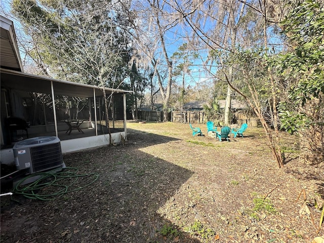 view of yard with central AC unit and a sunroom