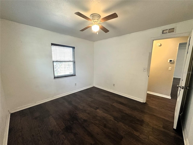 empty room with dark wood-type flooring and ceiling fan