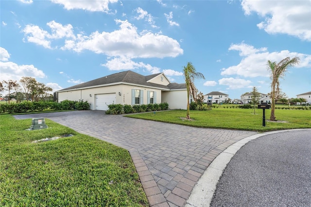 view of front of home featuring a garage and a front lawn