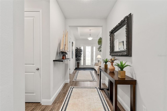 entryway with hardwood / wood-style floors and a textured ceiling