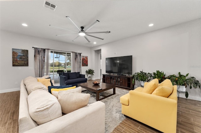 living room featuring hardwood / wood-style floors and ceiling fan