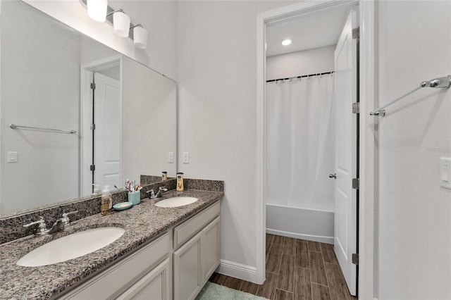 bathroom with vanity, shower / bath combo with shower curtain, and wood-type flooring