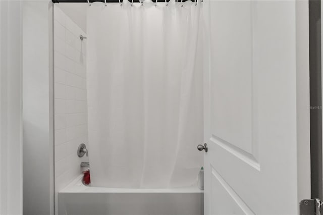 bathroom with shower / bathtub combination with curtain