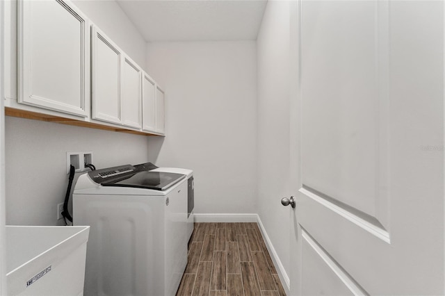 laundry room with dark wood-type flooring, washing machine and dryer, cabinets, and sink