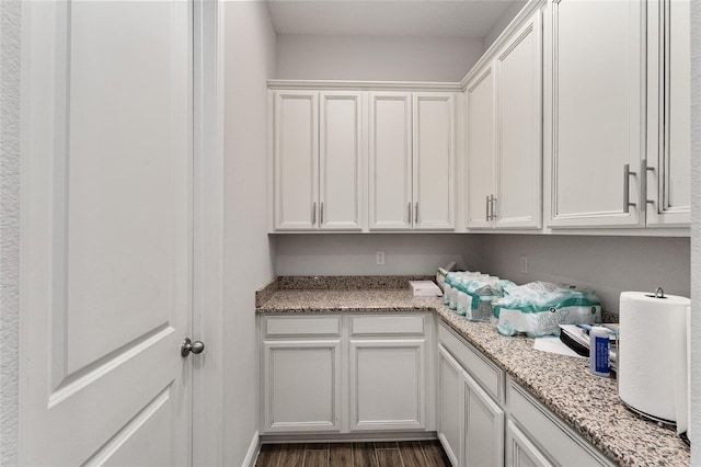 clothes washing area with dark hardwood / wood-style floors