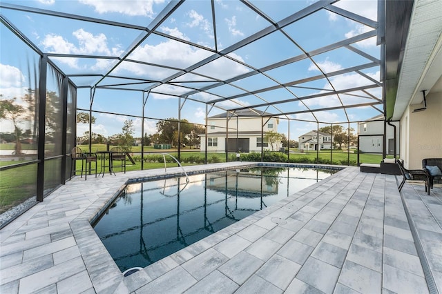 view of pool featuring a patio, a yard, and a lanai