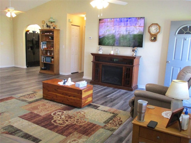 living room with ceiling fan and dark hardwood / wood-style floors